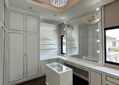 Elegant dressing room with ample storage and vanity area