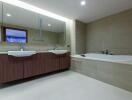 Modern bathroom with dual sinks and a large bathtub