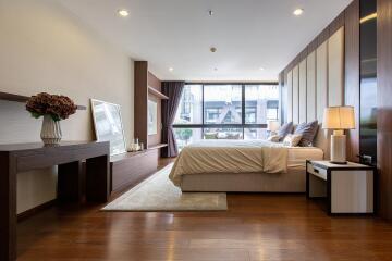 Elegant bedroom with modern furnishings and a large window