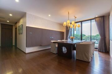 Spacious dining room with hardwood floors and modern lighting