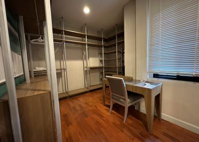 Spacious bedroom with a walk-in closet and a study desk