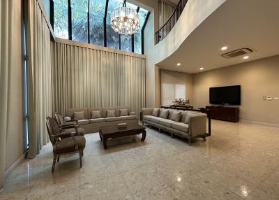 Spacious and modern living room with high ceiling and large window