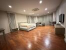 Spacious bedroom with modern amenities and hardwood flooring