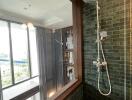 Modern bathroom with tiled walls and glass shower