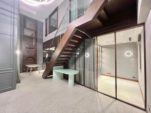 Modern interior with wooden stairs and glass partition