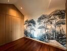 Spacious bedroom with artistic forest-themed wallpaper and hardwood floor