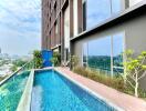 Modern apartment building with balcony swimming pool and city skyline