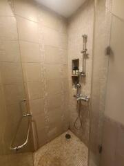 Modern bathroom with walk-in shower and beige tiles