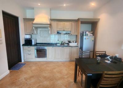 Modern kitchen with tiled flooring and equipped with stainless steel appliances