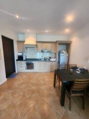 Modern kitchen with tiled flooring and equipped with stainless steel appliances