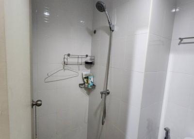 Modern bathroom with white tiled walls and walk-in shower