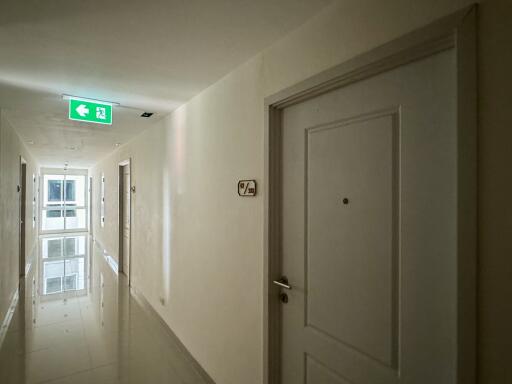 Brightly lit hallway with apartment doors