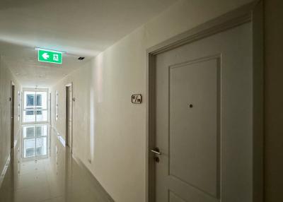 Brightly lit hallway with apartment doors