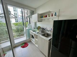 Modern kitchen with natural light and greenery view