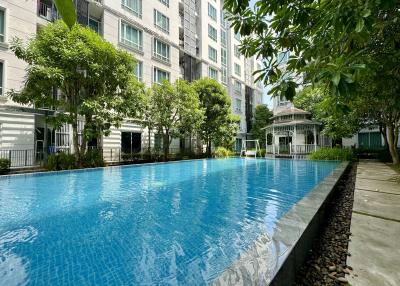 Residential building complex with outdoor swimming pool and garden