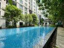 Residential building complex with outdoor swimming pool and garden