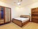 Spacious bedroom with wooden furnishings and flooring