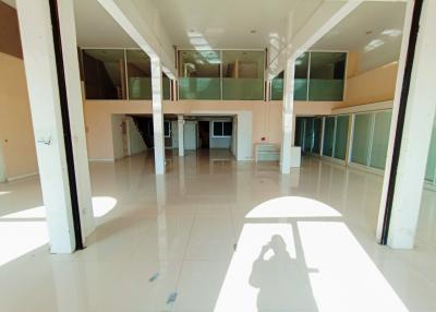 Spacious open floor plan of an empty building interior with large windows and abundant natural light