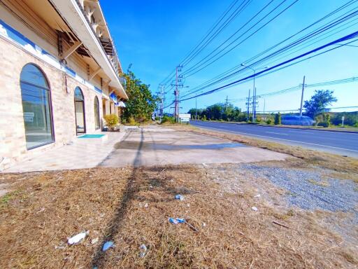 Exterior view of the building front with parking space and street