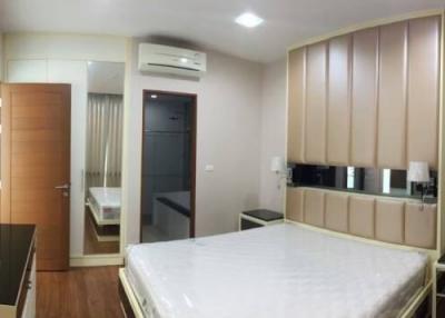 Spacious bedroom with modern furniture and ample storage