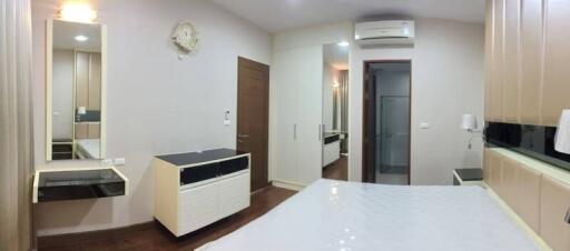 Modern bedroom with built-in wardrobe and air conditioning