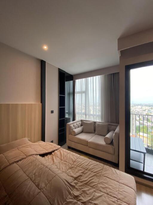 Modern bedroom with large windows and city view