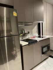 Modern kitchen with stainless steel appliances and grey cabinets