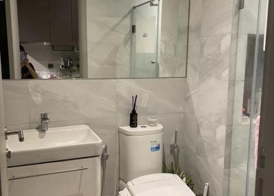 Modern bathroom with marble tiles and glass shower