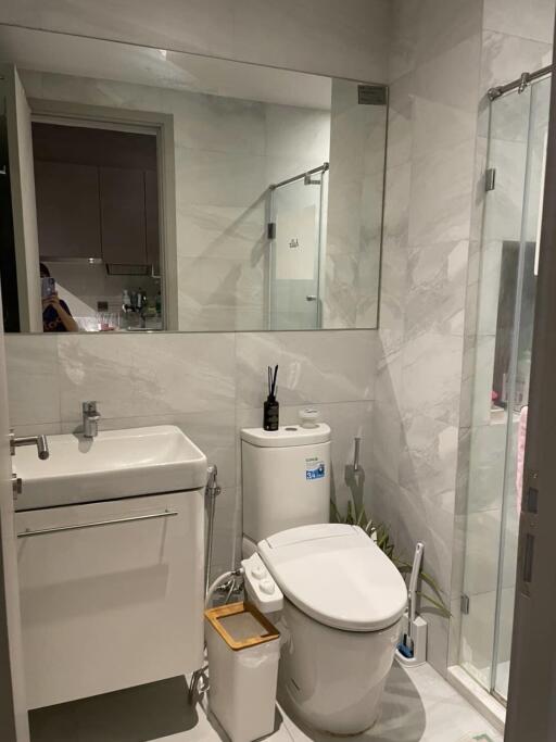 Modern bathroom with marble tiles and glass shower