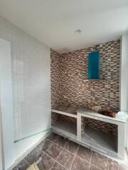 Unfinished bathroom interior with mosaic wall tiles and construction materials