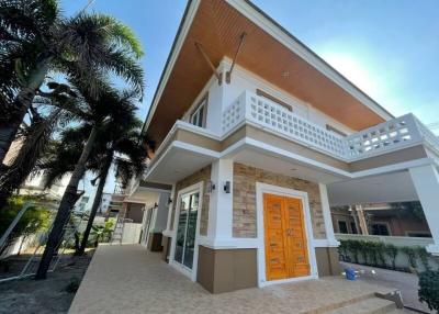 Spacious two-story house with a balcony and paved front yard