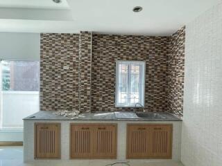 Modern kitchen with mosaic backsplash and wooden cabinets