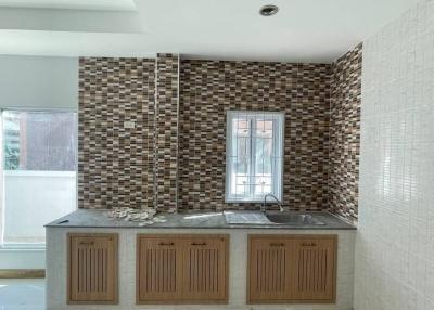 Modern kitchen with mosaic backsplash and wooden cabinets