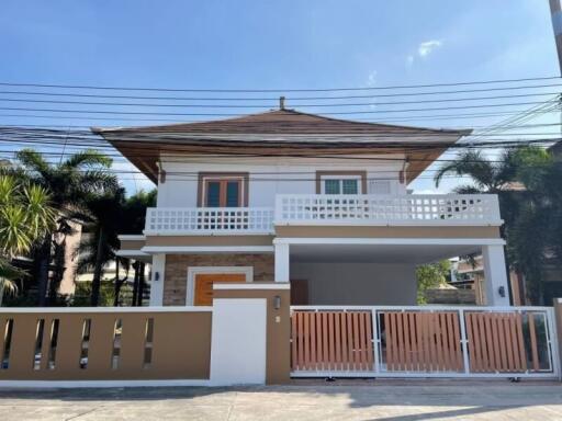 Modern two-story house with a balcony and a garage