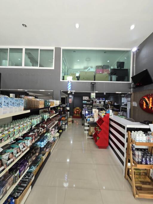 Spacious and well-stocked interior view of a retail store with shelves full of products