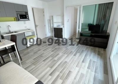 Modern studio apartment interior with open kitchen, living and sleeping area