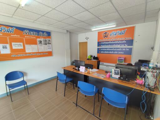 Spacious office interior with desks, chairs, and computers