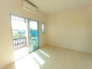 Bright and airy bedroom with balcony access and air conditioning unit