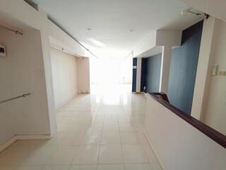 Spacious and bright corridor inside a building with tiled flooring
