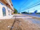 Street view of a building with parking space