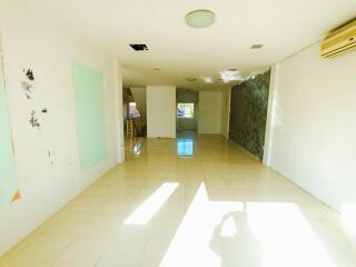 Bright spacious empty interior of a building with tiled floors and large windows