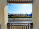 View from balcony overlooking road and open land