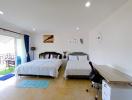 Spacious bedroom with double beds and balcony access