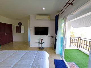 Spacious bedroom with balcony access and modern amenities