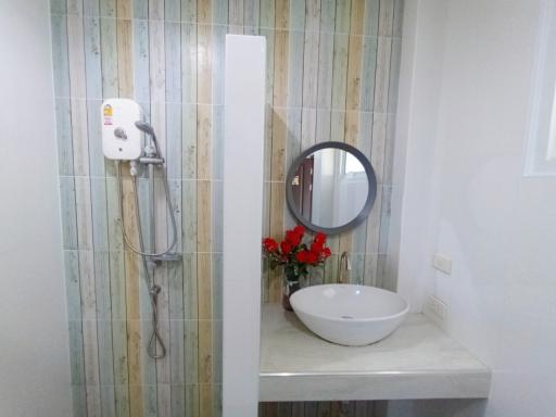 Modern bathroom interior with wall-mounted sink and shower