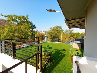 Spacious balcony with artificial grass and scenic view