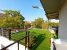 Spacious balcony with artificial grass and scenic view