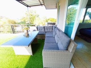 Cozy outdoor patio with comfortable seating and greenery