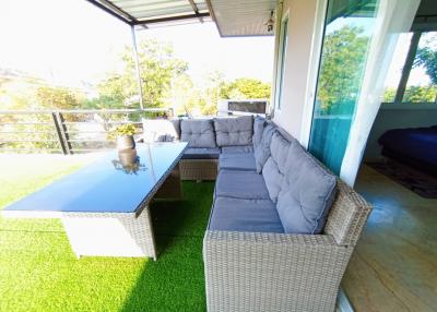 Cozy outdoor patio with comfortable seating and greenery