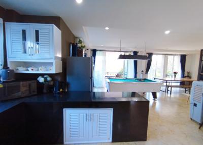 Modern kitchen with open layout and pool table